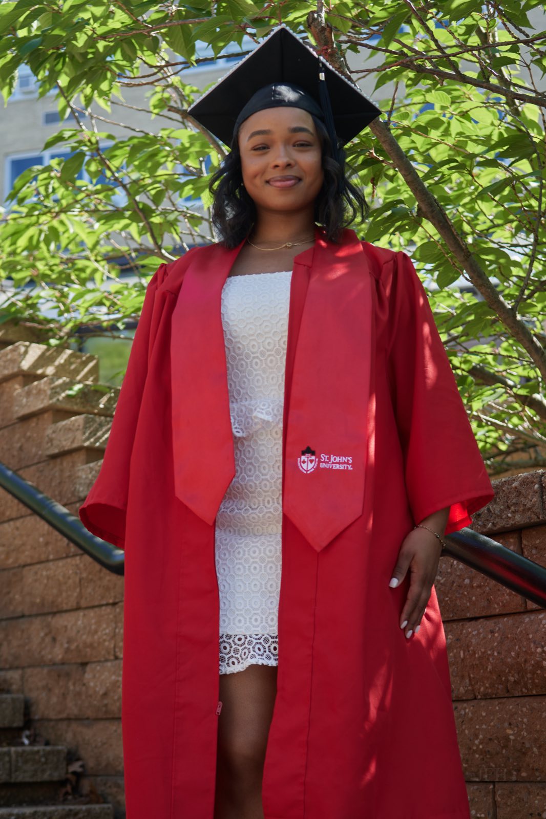 Portrait in cap and gown, looking to camera.